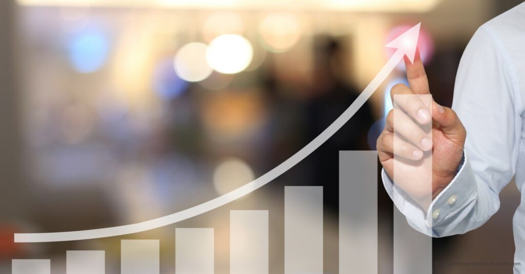 Keys to Improving Cash Flow and Maximizing Profitability business man showing growth on financial chart