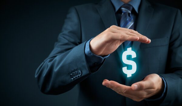 business man holding a money symbol to demonstrate savings