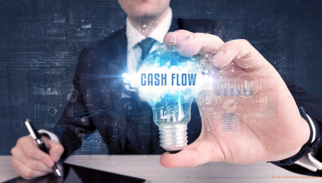 man holding cash flow light bulb