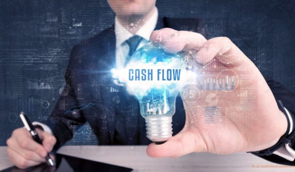 man holding cash flow light bulb