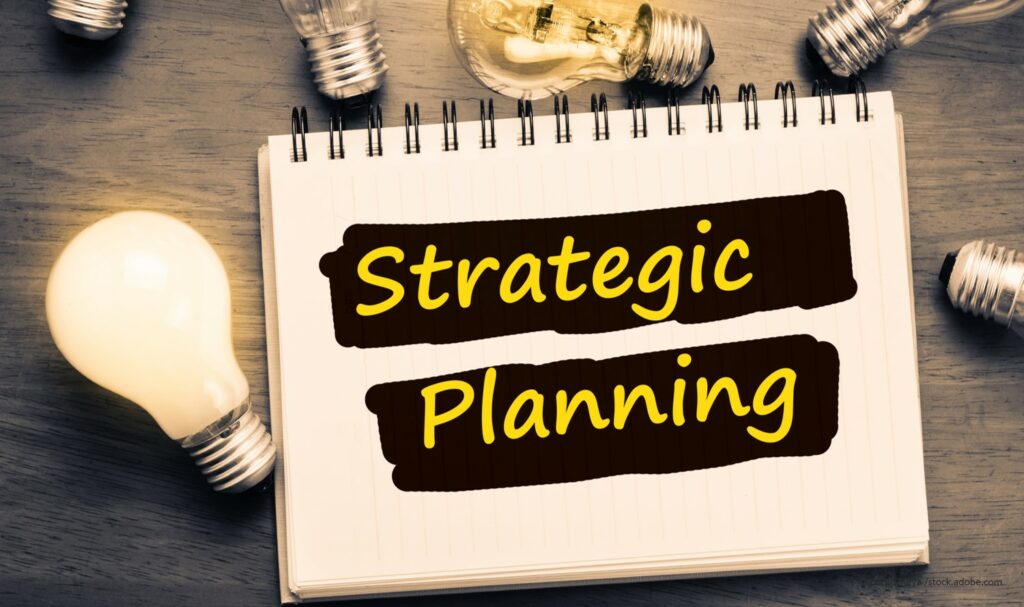 Notebook with Strategic Planning written with lightbulbs
